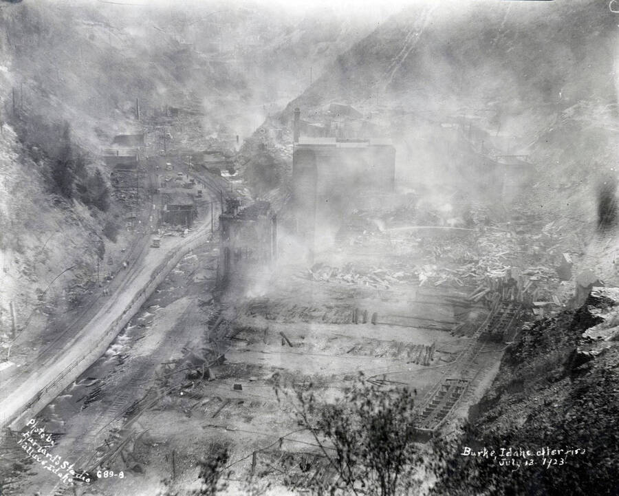 Images shows smoke rising from the smoldering ground in Burke after the fire July 13, 1923 which destroyed Hecla Mine.