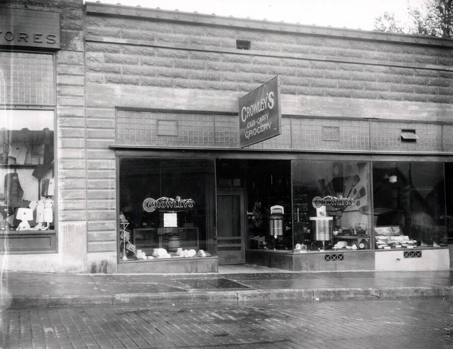 Exterior view of Crowley's Grocery, a Cash and Carry,  a part of the Morrow Retail Stores located on Bank Street in Wallace, Idaho, 1925.