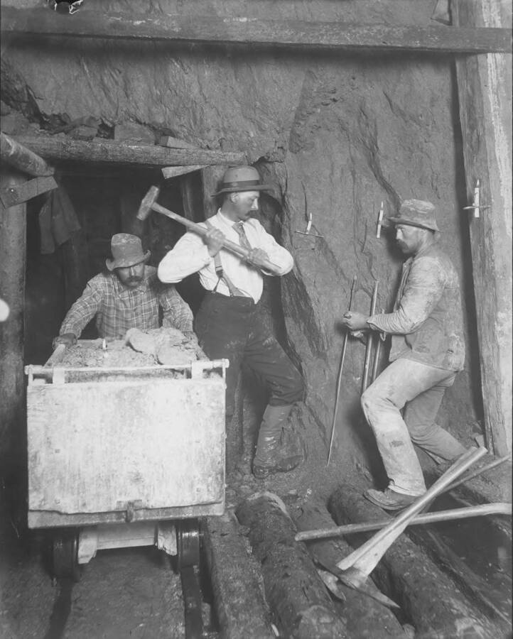 Tincup group hand mining with double jack.