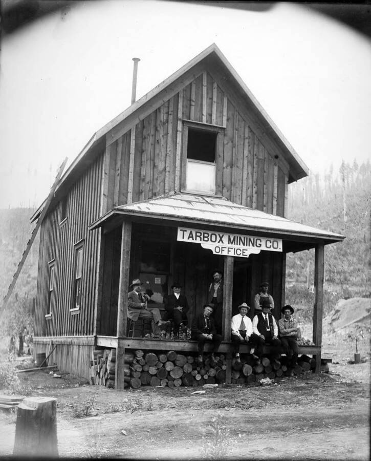 Men sitting on office steps, Tarbox Mining Co.