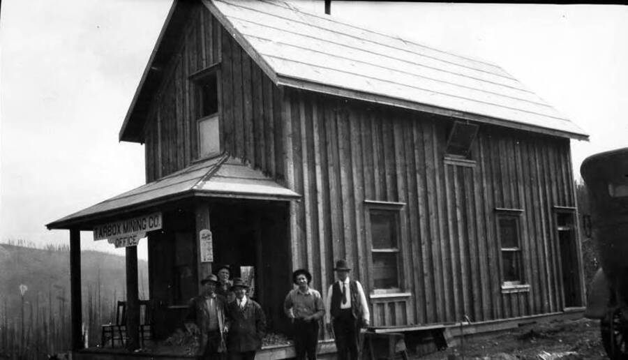 Group of men standing out side of the mining office