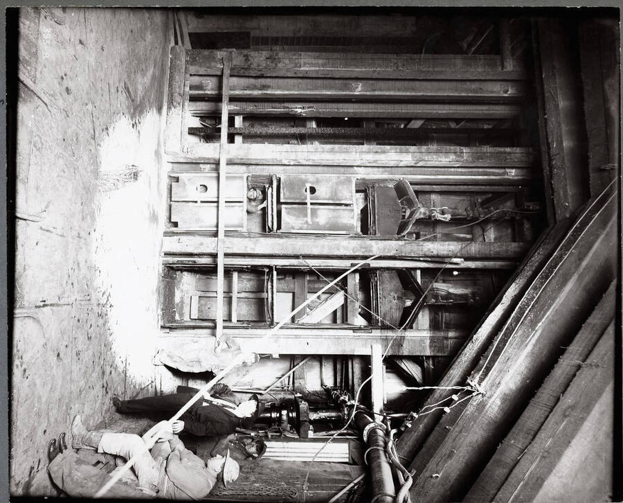 Interior of the mine showing cages or lifts with a man inside