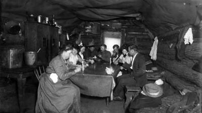 Hercules Cabin, Burke. Group examining ore samples. (Strike made July 2, 1901.)
