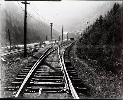 View of railroad tracks. Caption on front: "Northern Pacific Railway (tracks), Black Bear (Black Bear Accident)."