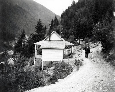 George Nick with dog outside of house in Burke, Idaho.