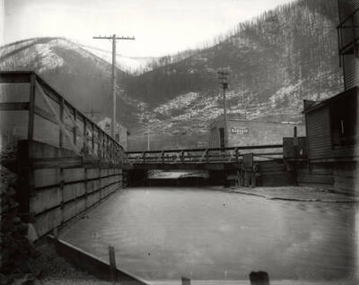 Bellinger's Bargain Store on the bank of the Coeur d'Alene River, right next to the bridge, in Wallace, Idaho. Taken for H.L. Day.