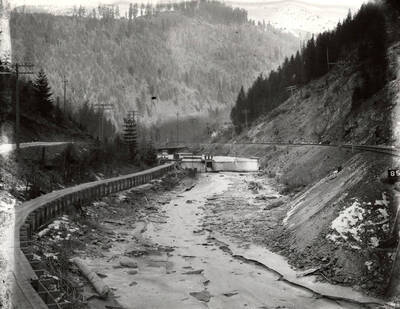 The Coeur d'Alene River with the railroad along the side near Wallace, Idaho. Taken for H.L. Day.