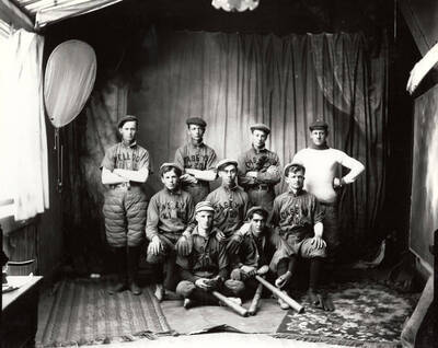 The boys of the Kellogg baseball team, wearing shirts that say "Casey's Kids" on them and holding baseball gloves and bats.
