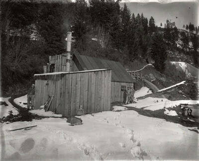 A few men standing next to buildings on Hector Mine.