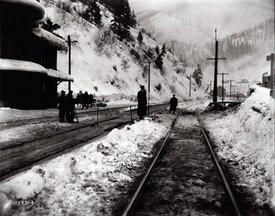 Image of people standing alongside train tracks by Wallace Northern Pacific Depot. Caption on front: "Potter accident - O.W.R.&N., Wallace."