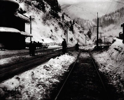 Image of people standing alongside train tracks by Wallace Northern Pacific Depot. Caption on front: "Potter accident - O.W.R.&N., Wallace."