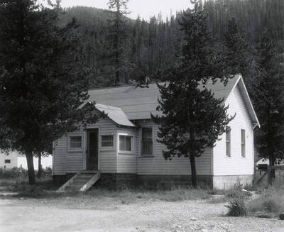 View of a house in Wallace, Idaho surrounded by trees. A real estate view taken for Idaho First National Bank.