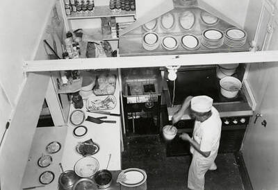 A view looking down on a man cooking in the kitchen at the Silvio Cafe in Wallace, Idaho.