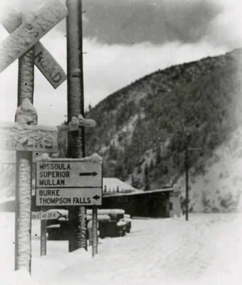 The signs at the highway junction covered in snow. Located in Wallace, Idaho at the "Y" where Burke and Mullan highways intersect.