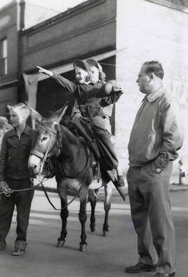 Children sitting on a donkey during the Elks Roundup parade in Wallace, Idaho.