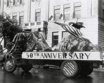 A float with "50th Anniversary" written on it driving in the Eagles parade in Wallace, Idaho.