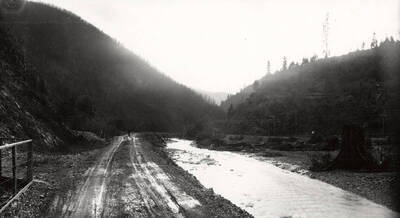 Dirt road with a creek beside it.