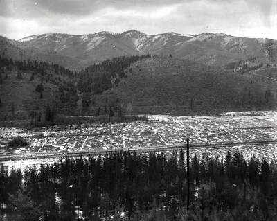 Valley scene with a barn in the distance.