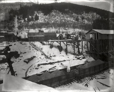 The railroad ore cars surrounded by snow on Stewart Mine in Wallace, Idaho.