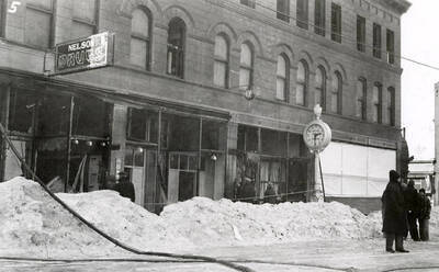The aftermath of the fire at the Ryan Hotel on Cedar Street in Wallace, Idaho. Nelson Drugs store can also be seen.