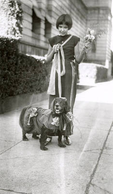 A girl with her dog at the Veterans pet parade in Wallace, Idaho.