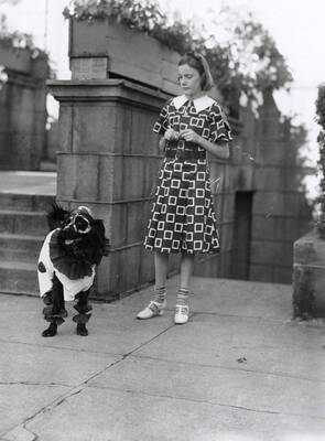 A girl with her dogs, who is dressed up, at the Veterans pet parade in Wallace, Idaho.