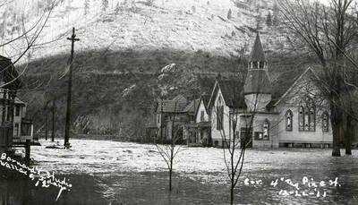 View of Corner Fourth and Pine Street during the Placer Creek flood in Wallace, Idaho.