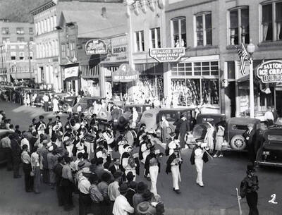 The marching band playing, while people gather along the sides to watch, during the Eagles Parade in Wallace, Idaho.
