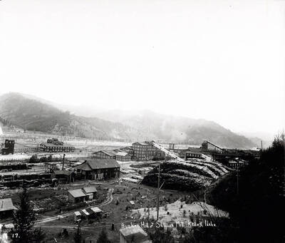 The milling plant at Bunker Hill and Sullivan Mill in Kellogg, Idaho [1912]; The plant capacity was 100-tons an hour. Image shows piles of lumber and various milling buildings.