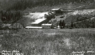 View of the buildings and mountains on the Polaris Mine in Wallace (i.e. Osburn), Idaho. The Polaris mill and change house can be seen.