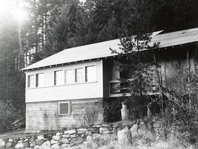 Exterior view of the Mortimer home on Coeur d'Alene Lake. The house is surrounded by trees.