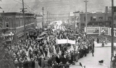 A crowd of people watching the opening of the temple during Elks parade in Wallace, Idaho.