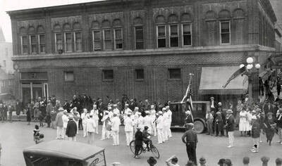 The band playing in the Elks parade in Wallace, Idaho, while people stand along the side watching.
