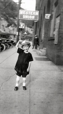 A little girl standing on the street during the Elks parade in Wallace, Idaho.
