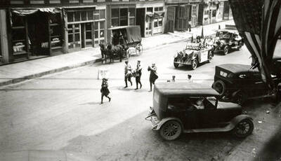 A few people walking in front of floats during the Fourth of July Parade in Wallace, Idaho.