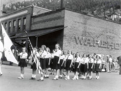 The Scouts and Campfire groups walking in the Children's parade during the Elks Roundup parade in Wallace, Idaho.