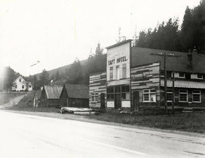 Exterior view of the Taft Hotel in Taft, Montana. Other buildings can be seen to the left of the hotel.