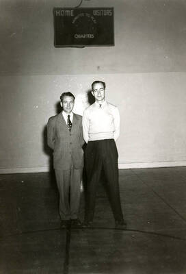 The Wallace High School football coaches, English and Otto Izzler, standing next to each other.