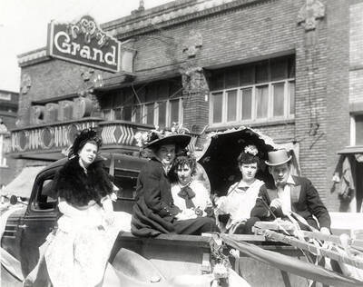 A group of people standing next to a float in Our Lady of Lourdes Academy's senior class parade in Wallace, Idaho.