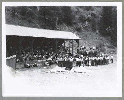 A boy wearing a derby hat and pulling a wagon with a tent cover reading, "Mullan '49'er or buzt" during the Children's Parade.
