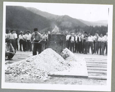 Two men competing in a contest on making holes for blasting powder (also known as singlejacking) during the Mullan '49'er Parade.
