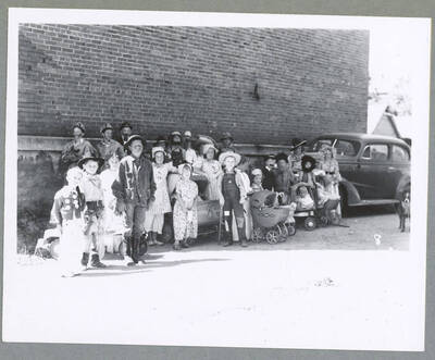 A crowd watches on as men compete in an ore car loading contest during the Mullan '49'er Parade.
