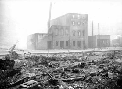 Image is of debris from a damaged building in Wallace, Idaho. Forest fire 1910.