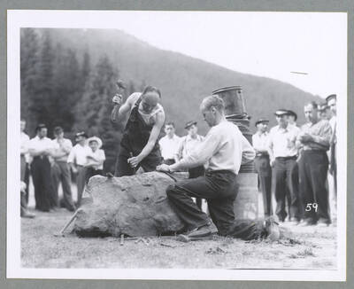 A man riding a motorcycle up a hill during the Mullan '49'er Parade.