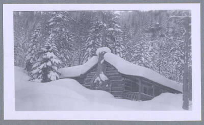 A snow-covered cabin. Photograph taken for T. Lewis