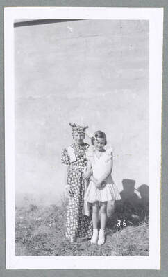 A man and woman in formal attire walking down the street during the Children's Parade.