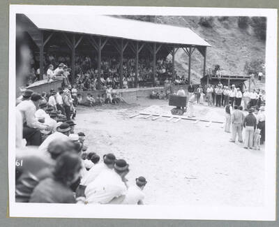 Two men competing in a contest on making holes for blasting powder (also known as singlejacking) during the Mullan '49'er Parade.