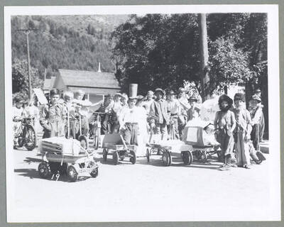 Children in costume pushing babies in carriages during the Children's Parade.