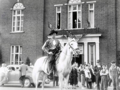 Dr. Paul Marvin Ellis riding his horse Bill in the Elks Roundup parade in Wallace, Idaho. Dr. Ellis was the head of the Idaho State Medical Association and a local practitioner