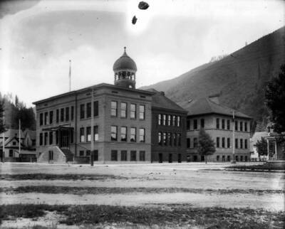 Image of the outside of the Wallace High School, after the awning covering the front steps was added.